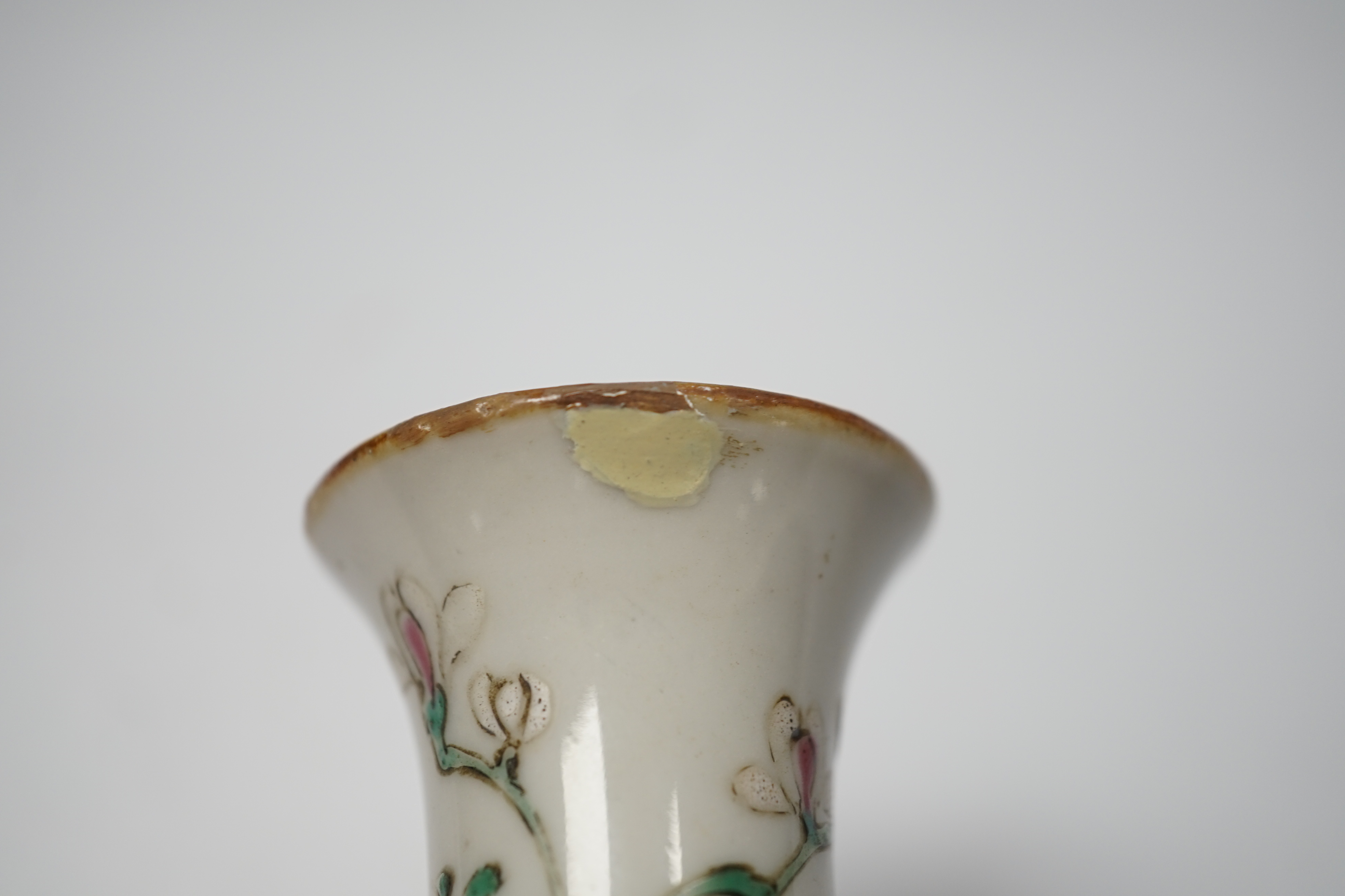 An 18th century Chinese enamelled porcelain figure of a lady standing by rockwork, a similar miniature vase and a blue and white tea caddy and cover, largest 17cm high